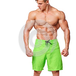 athletic man showing muscular body and sixpack abs, isolated over white background. Strong male nacked torso