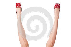bare female legs in elegant red stilettos