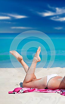 Sexy beach bikini beautiful woman relaxing sunbathing on tropical vacation.