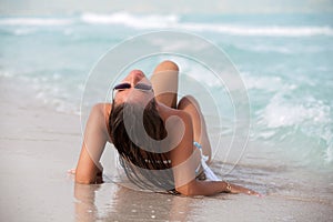 beach woman sunbathing in bikini.