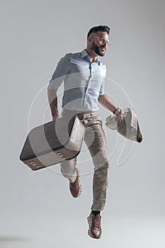 Sexy bearded man looking to side while jumping in the air