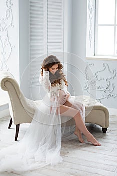 Sexy beatifull pregnant woman at white dress