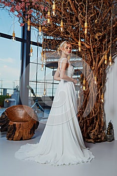 Sexy beautiful blonde woman pretty bride wedding big day marriage ceremony in summer garden wearing long silk and lace white dress