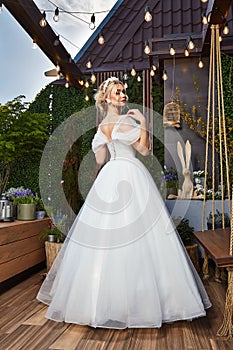 Sexy beautiful blonde woman pretty bride wedding big day marriage ceremony in summer garden wearing long silk and lace white dress