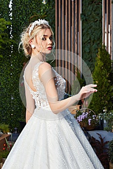 Sexy beautiful blonde woman pretty bride wedding big day marriage ceremony in summer garden wearing long silk and lace white dress