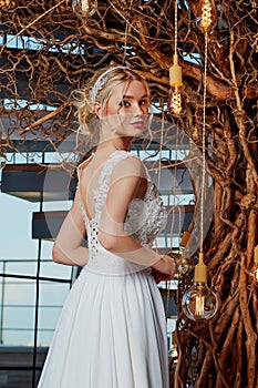 Sexy beautiful blonde woman pretty bride wedding big day marriage ceremony in summer garden wearing long silk and lace white dress