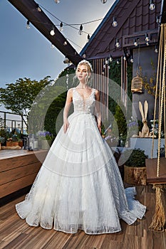 Sexy beautiful blonde woman pretty bride wedding big day marriage ceremony in summer garden wearing long silk and lace white dress