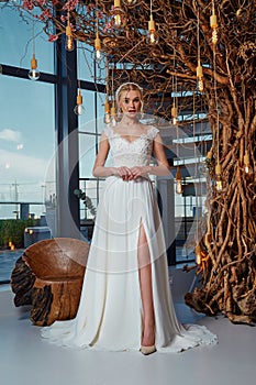 Sexy beautiful blonde woman pretty bride wedding big day marriage ceremony in summer garden wearing long silk and lace white dress