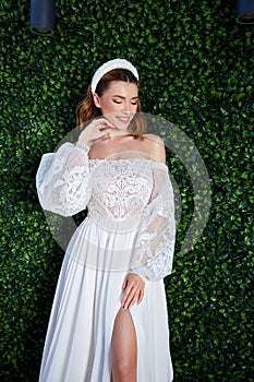 Sexy beautiful brunette woman pretty bride wedding big day marriage ceremony in summer garden wearing long silk and lace white