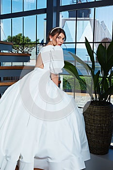 Sexy beautiful brunette woman pretty bride wedding big day marriage ceremony in summer garden wearing long silk and lace white