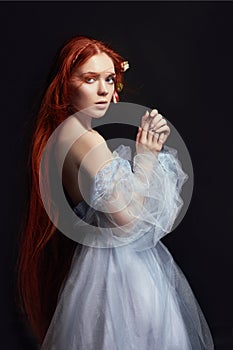 beautiful redhead girl with long hair in dress cotton retro. Woman portrait on black background. Deep eyes. Natural beauty