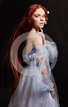 beautiful redhead girl with long hair in dress cotton retro. Woman portrait on black background. Deep eyes. Natural beauty