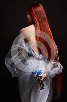 beautiful redhead girl with long hair in dress cotton retro. Woman portrait on black background. Deep eyes. Natural beauty