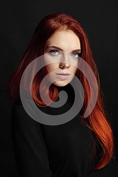 beautiful redhead girl with long hair. Perfect woman portrait on black background Gorgeous hair and deep eyes. Natural beauty