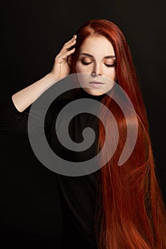 beautiful redhead girl with long hair. Perfect woman portrait on black background Gorgeous hair and deep eyes. Natural beauty