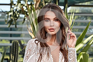 Sexy beautiful woman bride evening party makeup pure natural skin care cosmetic healthy curly brunette hair manicure hand wear