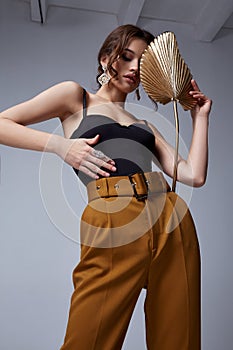 Sexy beautiful woman fashion glamour model brunette hair makeup wear silk skinny blouse trousers clothes for every day casual