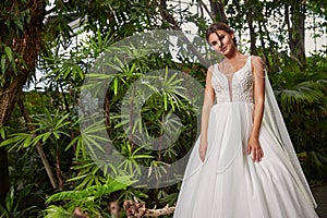 Sexy beautiful woman pretty bride wedding big day marriage ceremony in summer garden wearing long silk and lace white dress bright