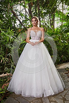 Sexy beautiful woman pretty bride wedding big day marriage ceremony in summer garden wearing long silk and lace white dress bright