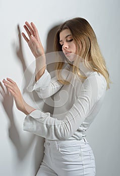 Sexy beautiful woman in white clothes posing in studio with white background
