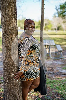 Sexy big black beautiful BBW model posing outdors in an animal print dress