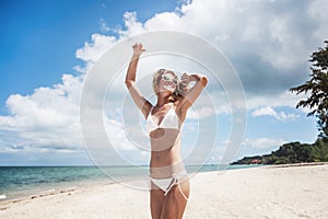 bikini body woman playful on paradise tropical beach having