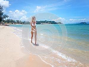 bikini body woman playful on paradise tropical beach having