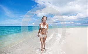 bikini body woman playful on paradise tropical beach having