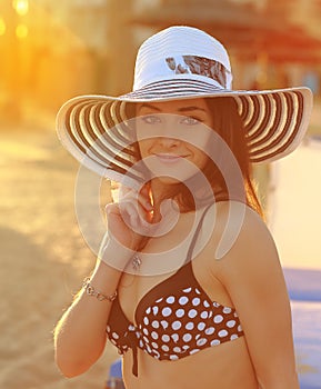 bikini woman in hat looking on