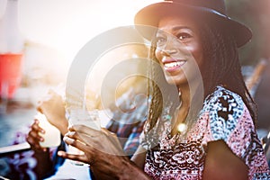 Sexy black woman drinking cocktail in summer and enjoying her vacation