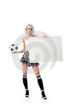 sexy blond woman in short plaid skirt with football ball and empty banner posing