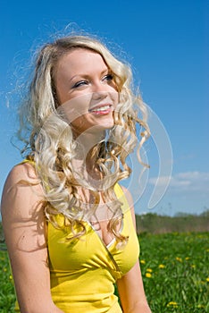 blonde on background of green meadow