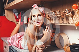 Woman Laying And Smiling With Cupcake photo