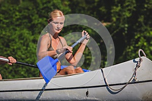 Sexy blonde rowing in canoe