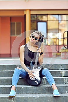 blonde woman with electric guitar