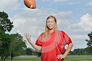 blonde woman playing American football
