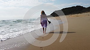Sexy blonde woman walking on a beach