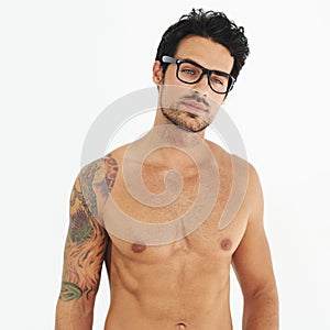 Sexy body, man with tattoo, glasses and beard or fit, muscular or healthy and shirtless beauty, fashion or style