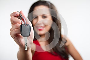 brunette holding a car key photo