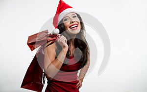 brunette holding Christmas red shopping bags photo