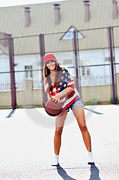 brunette woman playing basketball outdoor