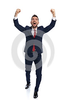 Sexy businessman feeling excited and celebrating success