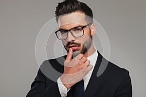 businessman flirting with thumb on lips