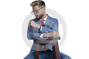 Sexy businessman sitting on a chair, resting his arms
