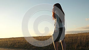 Sexy businesswoman girl running in the countryside. business woman walking along a country road with a briefcase in her