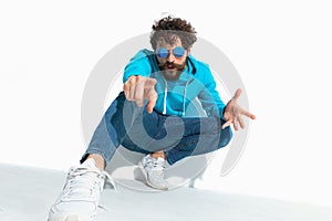 Sexy casual man pointing at the camera