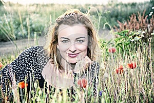 caucasian woman and corn poppy flowers, blue filter