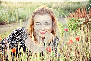 caucasian woman and corn poppy flowers