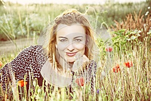 caucasian woman and corn poppy flowers, yellow filter