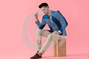 Sexy cool smart casual guy holding elbow on knww